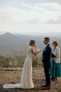Bride and groom laughing during their vows at the elopement in Sedona, Arizona.