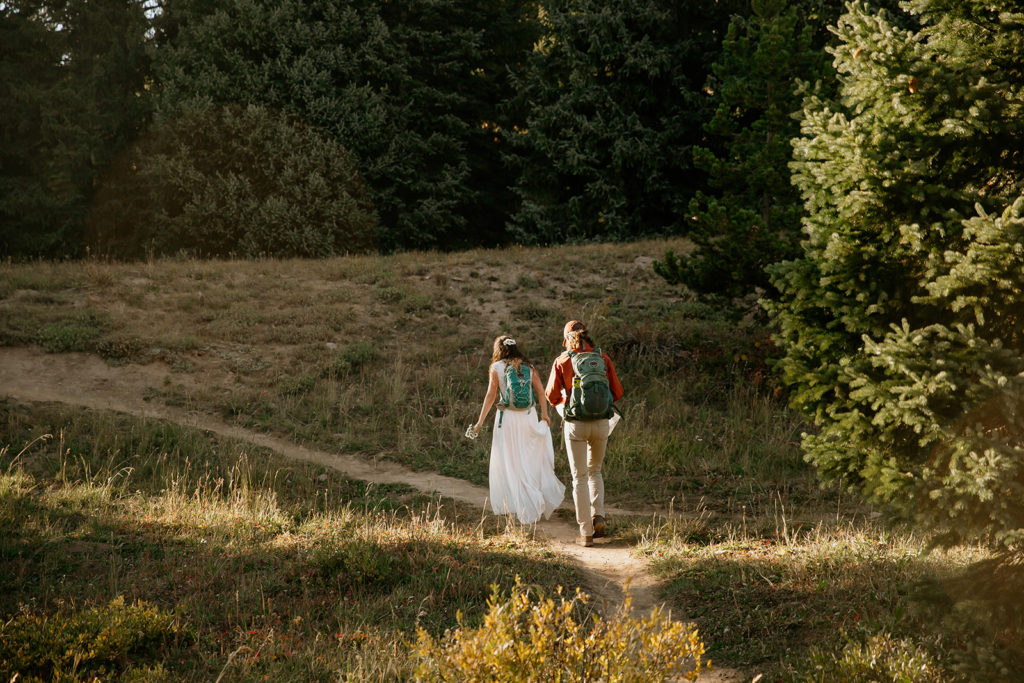 Bride and groom hiking to their ceremony location at their Colorado elopement.