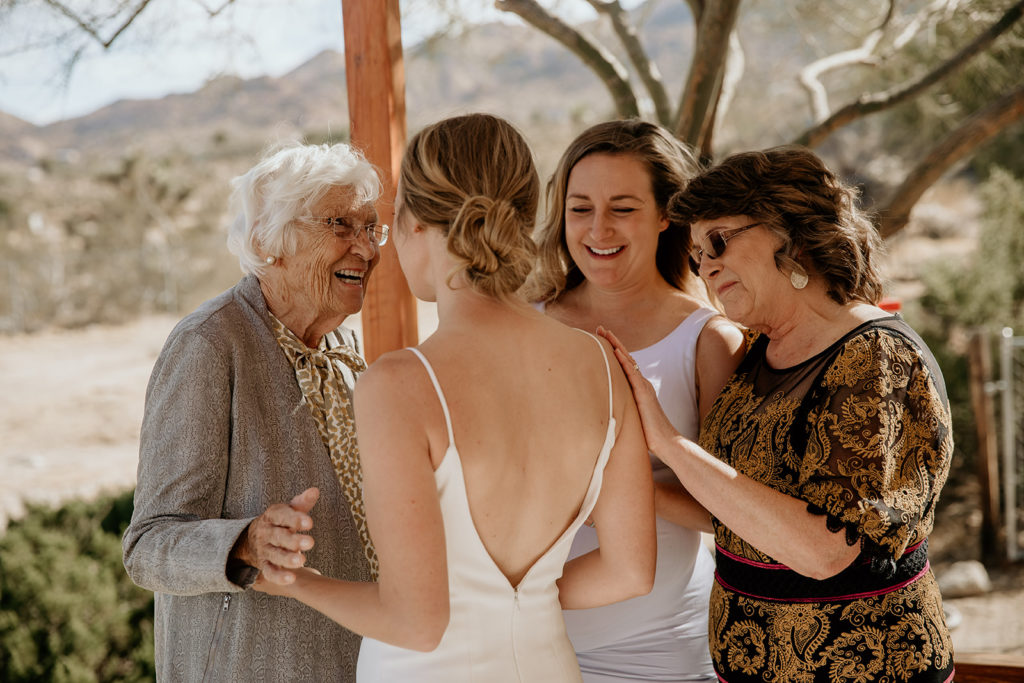 bride with grandma and mother while getting ready for elopement in Joshua treee