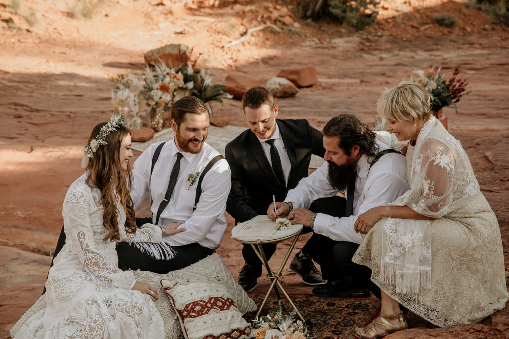 Bride and groom with family at their elopement in the red rocks of Sedona, Arizona