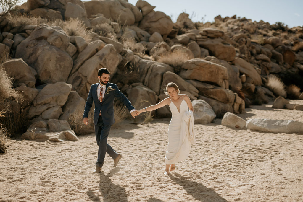 Bride and groom hiking at their Joshua tree elopement