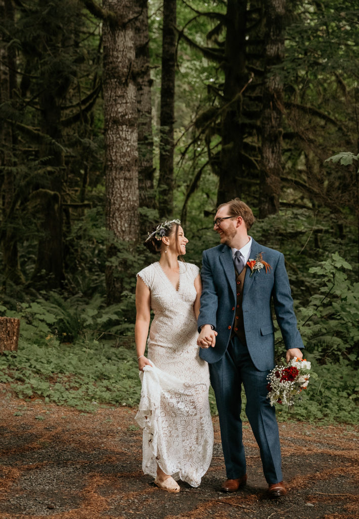 bride and groom walking at their elopement in mt. rainier national park