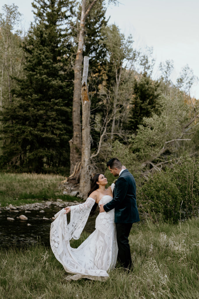bride and groom by a creek at their elopement in New Mexico