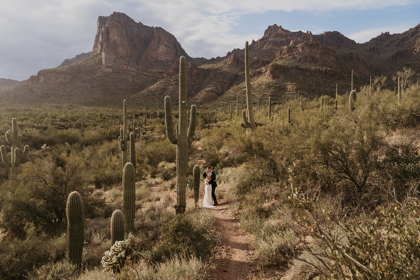 bride and groom hiking in the desert on their elopement day