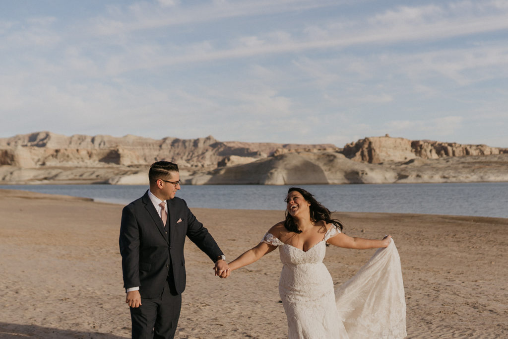 bride and groom dancing on the beach of Lake Powell on their wedding day