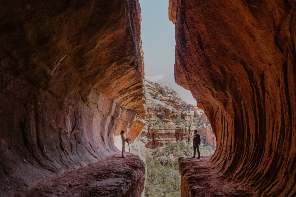 bride and groom standing in a cave on their sedona elopement
