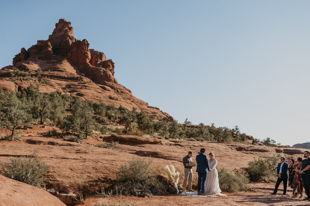 bride and groom having their elopement ceremony at bell rock in sedona arizona