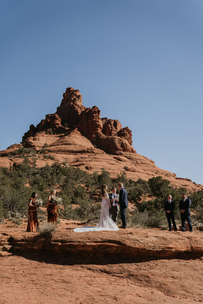 bride and groom getting married in sedona with bell rock in the background