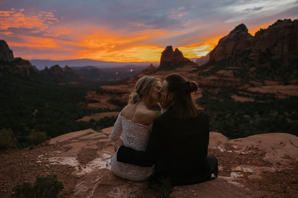bride and groom kissing with the sunset in the background in sedona arizona
