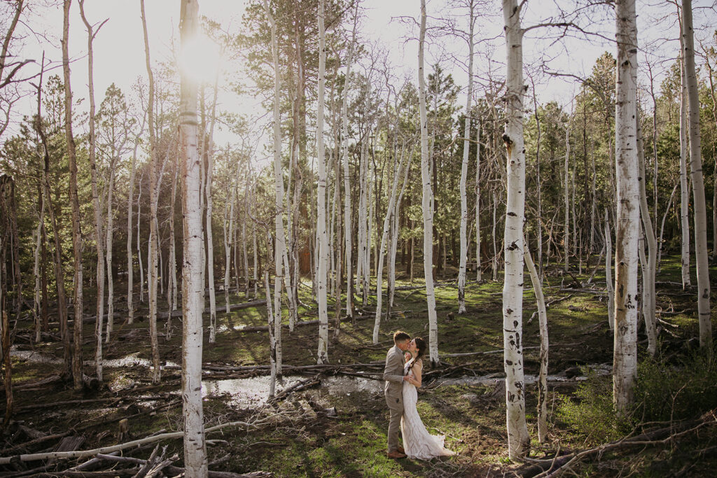 couples kissing at their elopement in the forest in flagstaff arizona