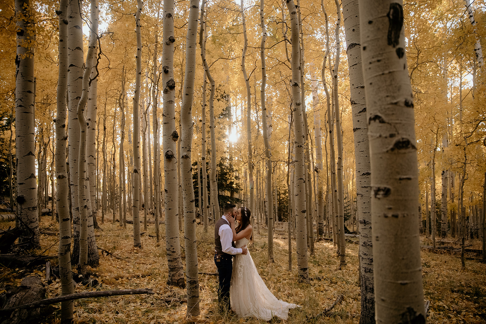 couple kissing at the flagstaff wedding in golden aspen trees
