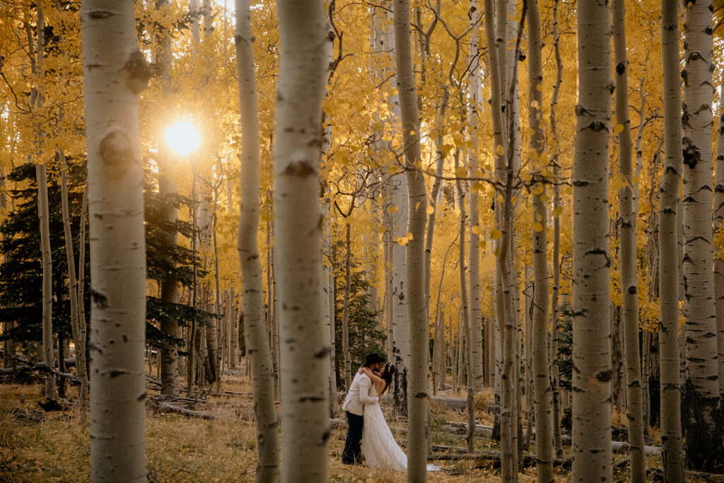 couple kissing in autumn aspen trees in Flagstaff arizona
